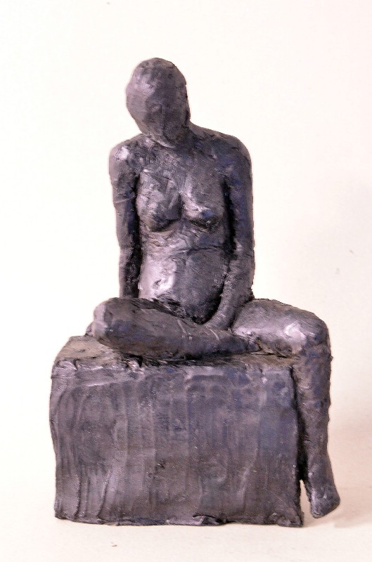 Kvinde siddende på klods