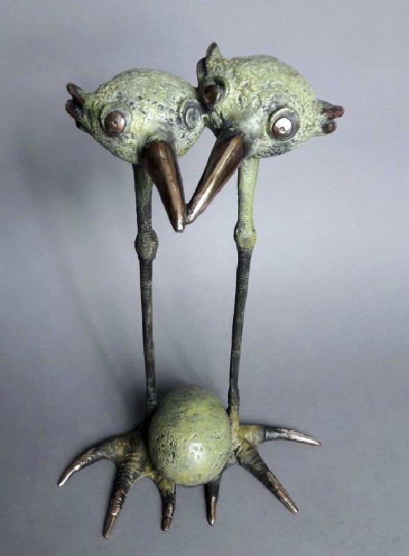 Feathery Birds With An Egg